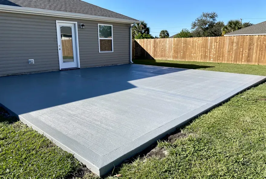 Smooth freshly finished concrete patio with clean edges in a suburban backyard in Marrero Louisiana
