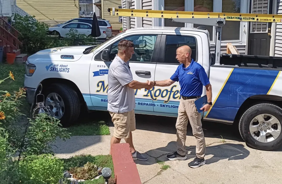 Traditional tiled roof with ornate detailing against sky