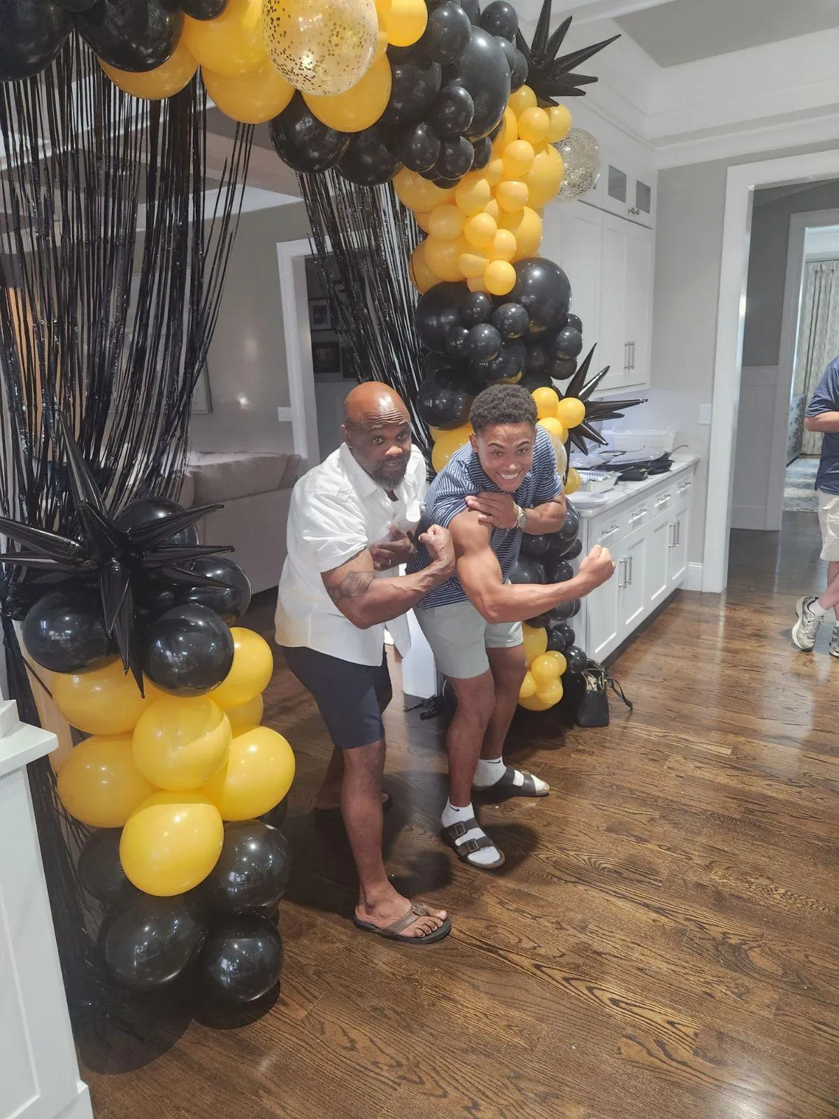 a living room filled with furniture and a kitchen