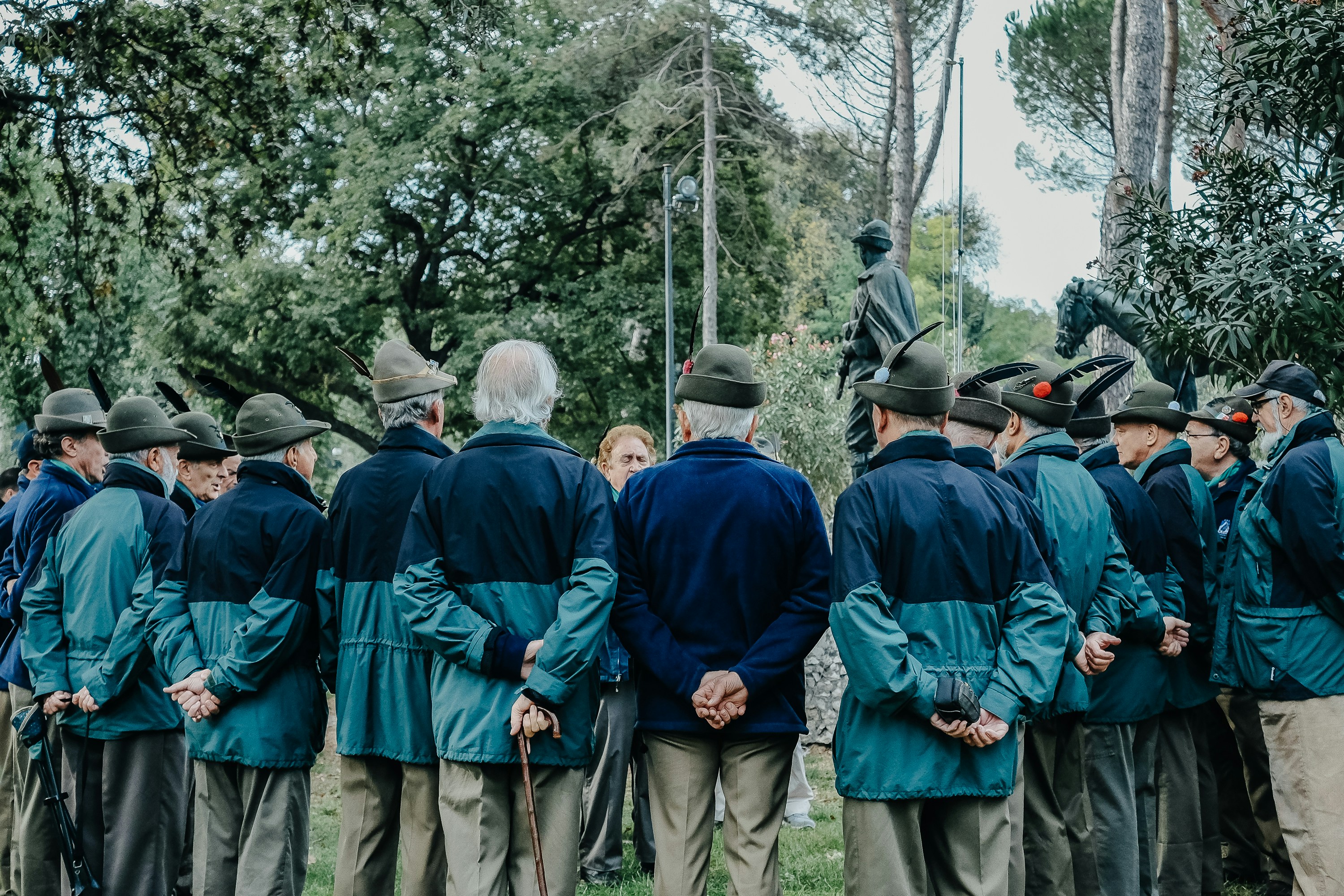 Group of travelers listening to a guide at a World War I memorial in Europe, illustrating educational history travel experiences.