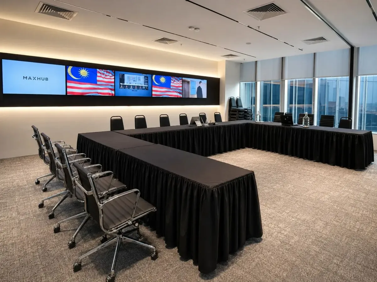 The Synergy Suite at Maxsmart Event Space arranged with classroom tables facing the LED wall.