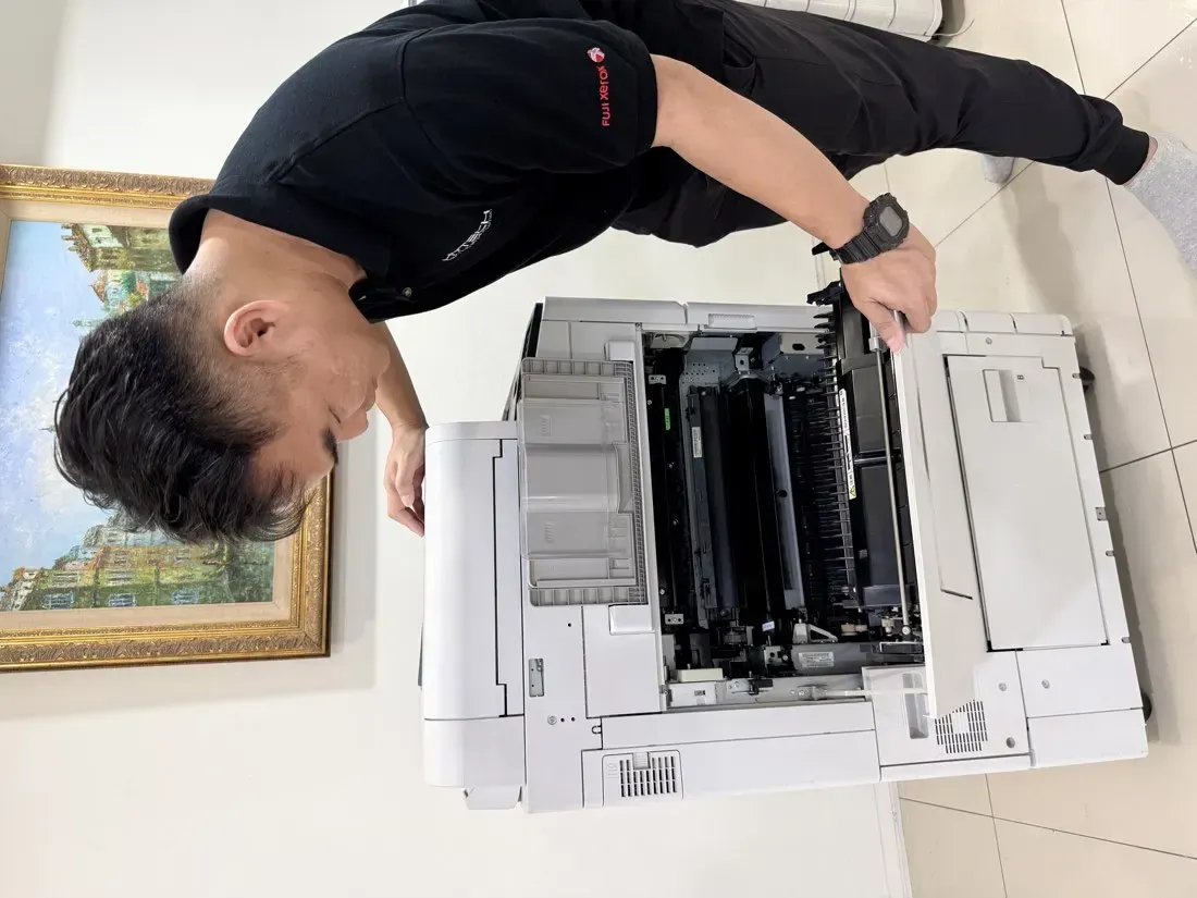 Hytech technician servicing a copier on-site