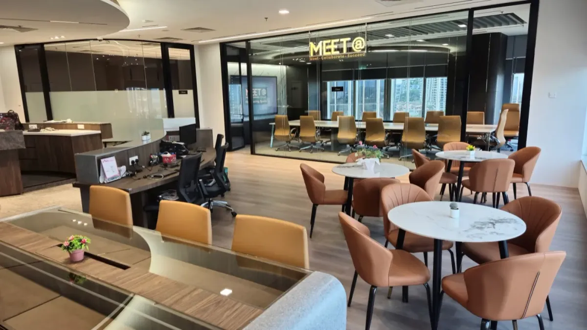 The Synergy Suite at Maxsmart Event Space arranged in classroom style with tables facing the presentation displays.