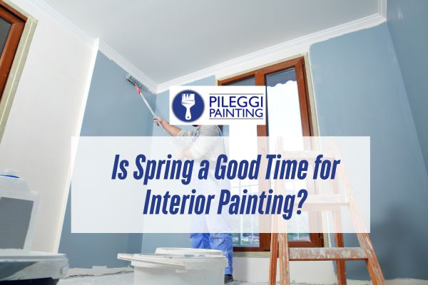man painting a wall with blue paint with a caption Is Spring a Good Time for Interior Painting
