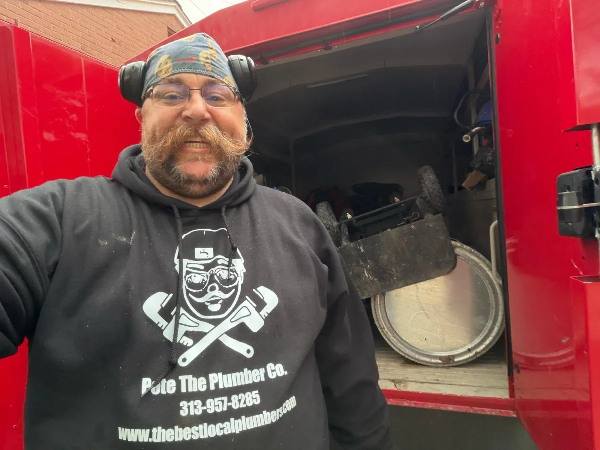 a person wearing a hard hat and holding a hammer