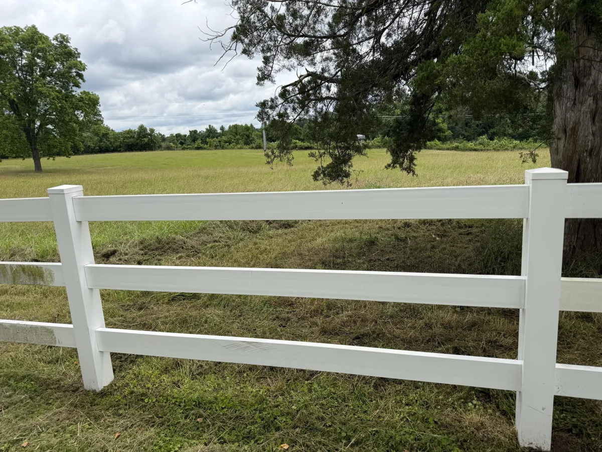 Clean white vinyl fence after professional exterior washing in Ripley, highlighting detailed house washing services.