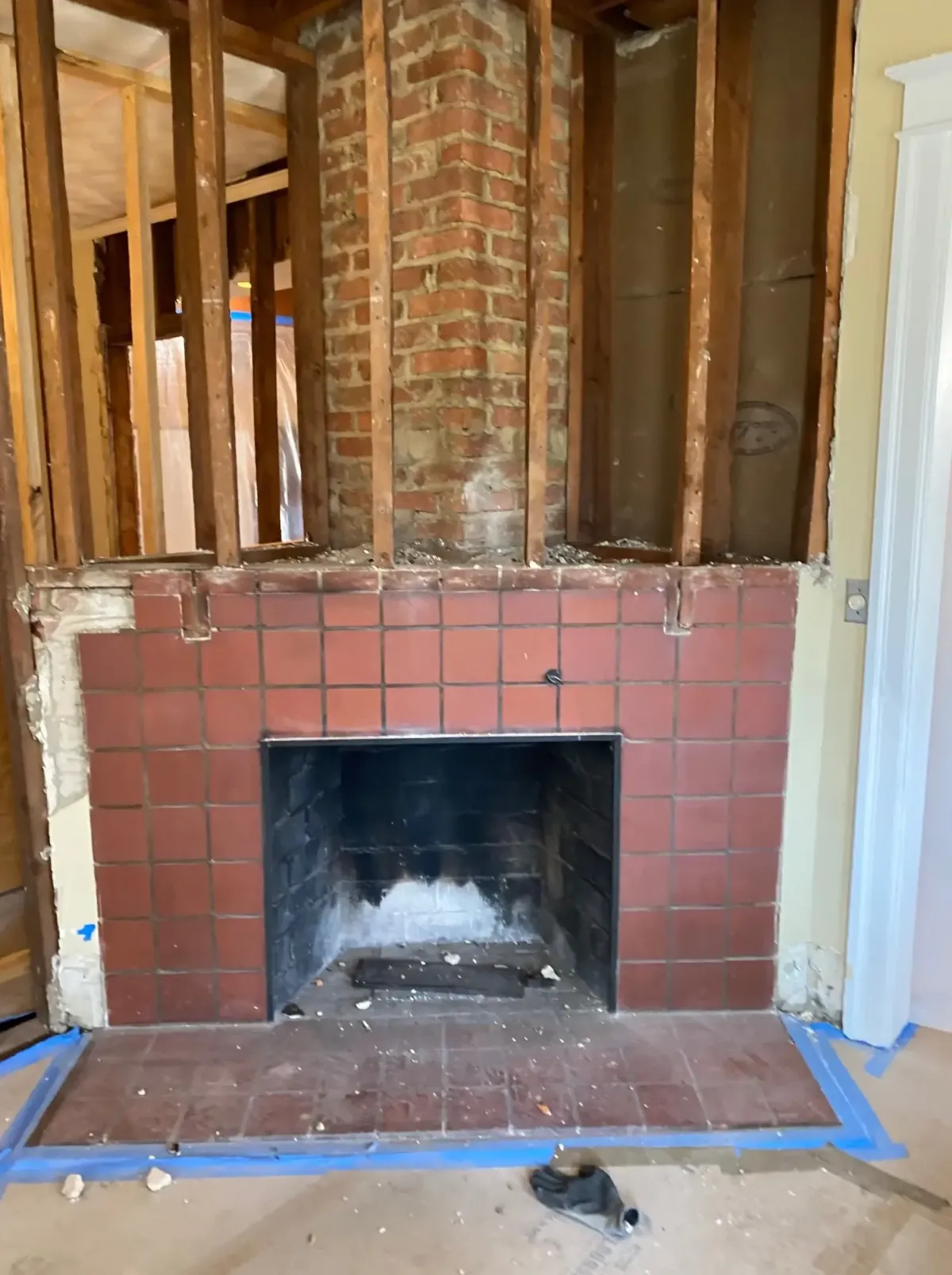 Arlington Virginia 100 year old home with corner fireplace and chimney before removal — living room and dining room separated by load bearing wall