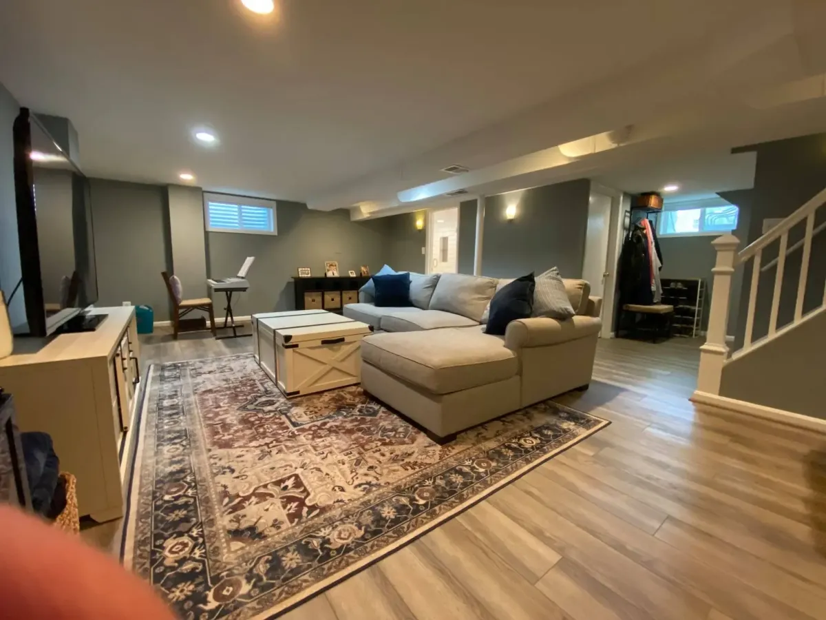 Arlington basement remodel showing recessed lighting, updated drywall, and LVP flooring