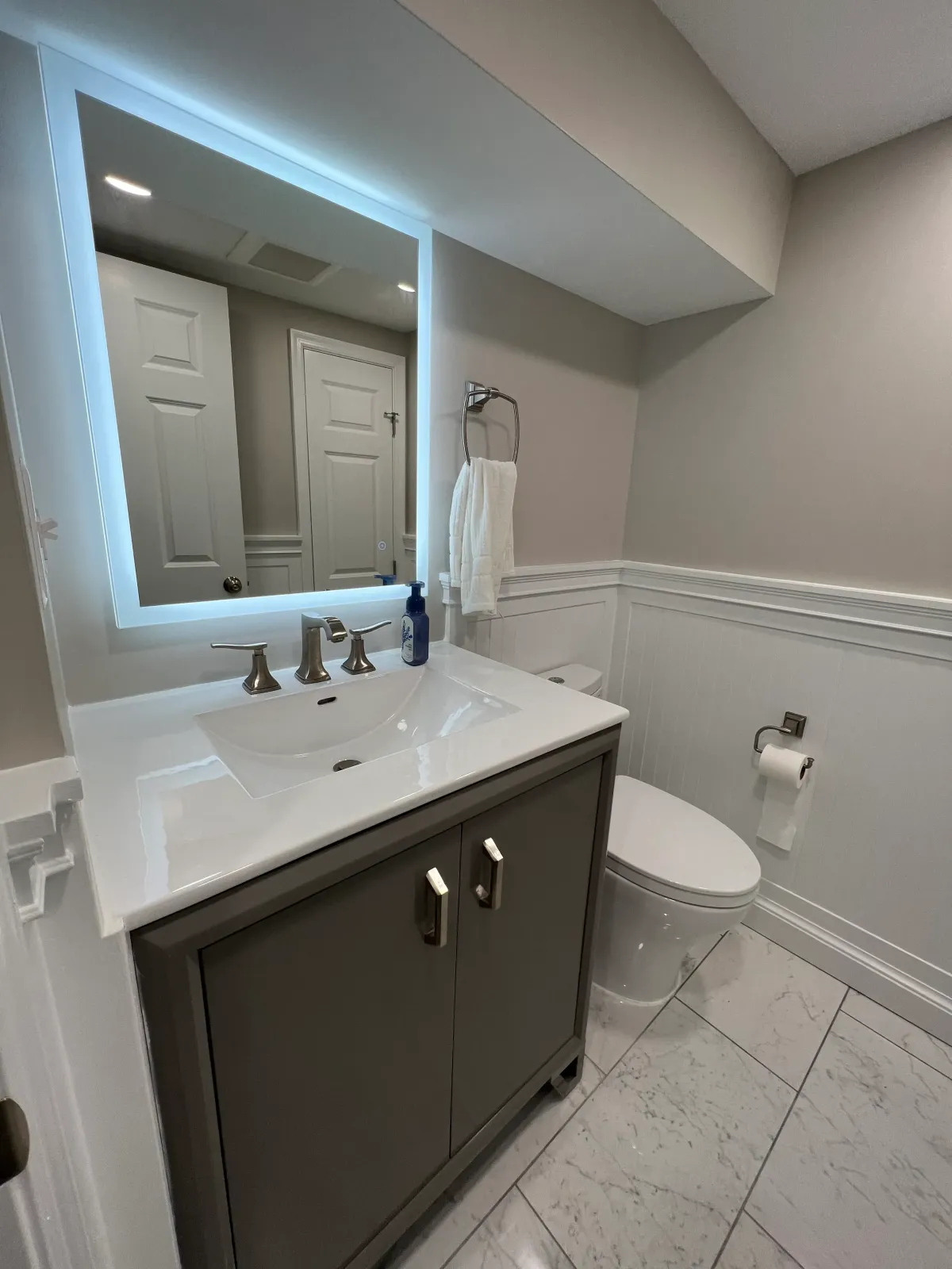 Arlington Virginia 1930s basement powder room conversion replacing unused 1970s bathroom