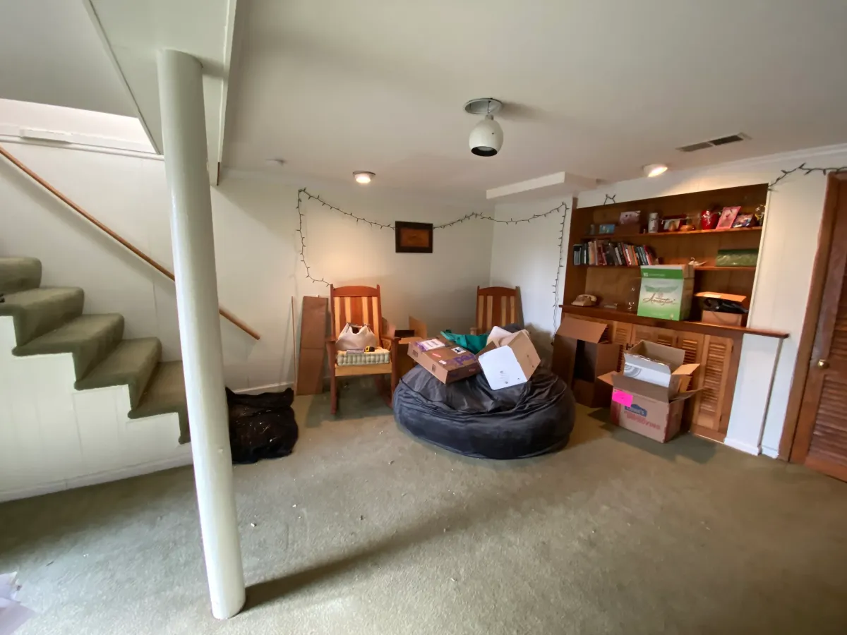 Arlington Virginia 1930s basement before remodel with lally column low staircase clearance and unused 1970s bathroom