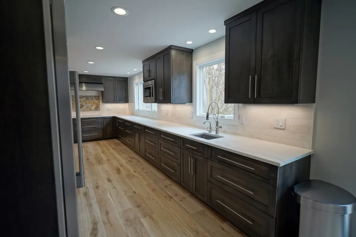 Oakton Virginia completed open concept kitchen and living room with new cabinets countertops flooring and lighting