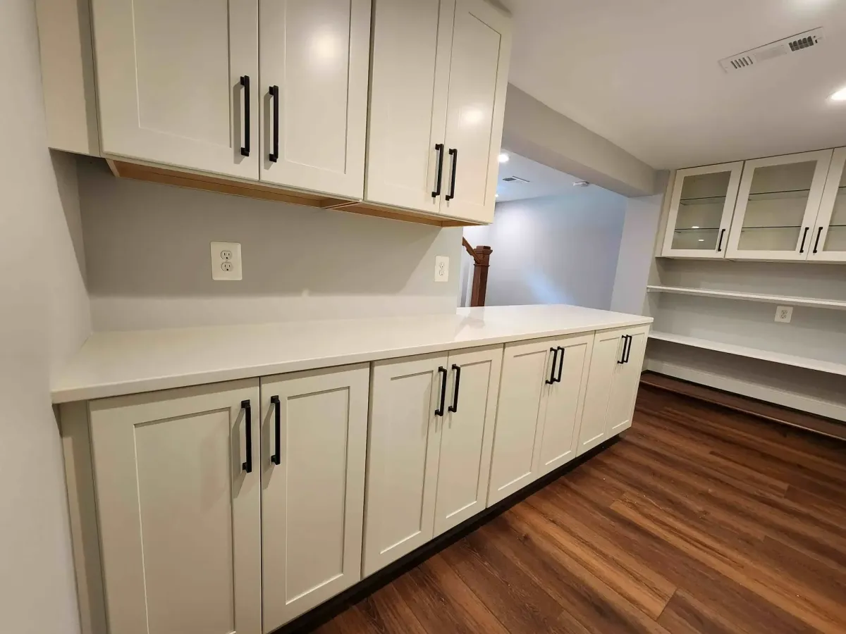 Completed lower level family room in Arlington basement remodel with recessed lighting and LVP flooring