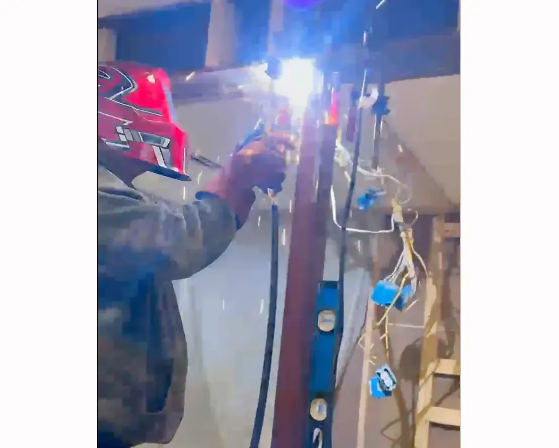Engineer-specified steel post anchored to 52-inch concrete footer replacing deck post under steel beam, Arlington Virginia