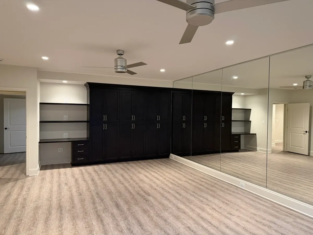 Falls Church basement gym with mirror wall added during full basement remodel by HandyMensch