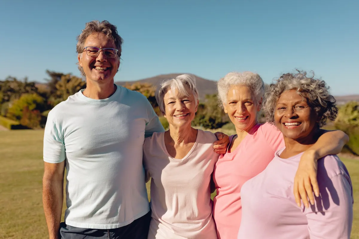 Smiling friends standing together outdoors