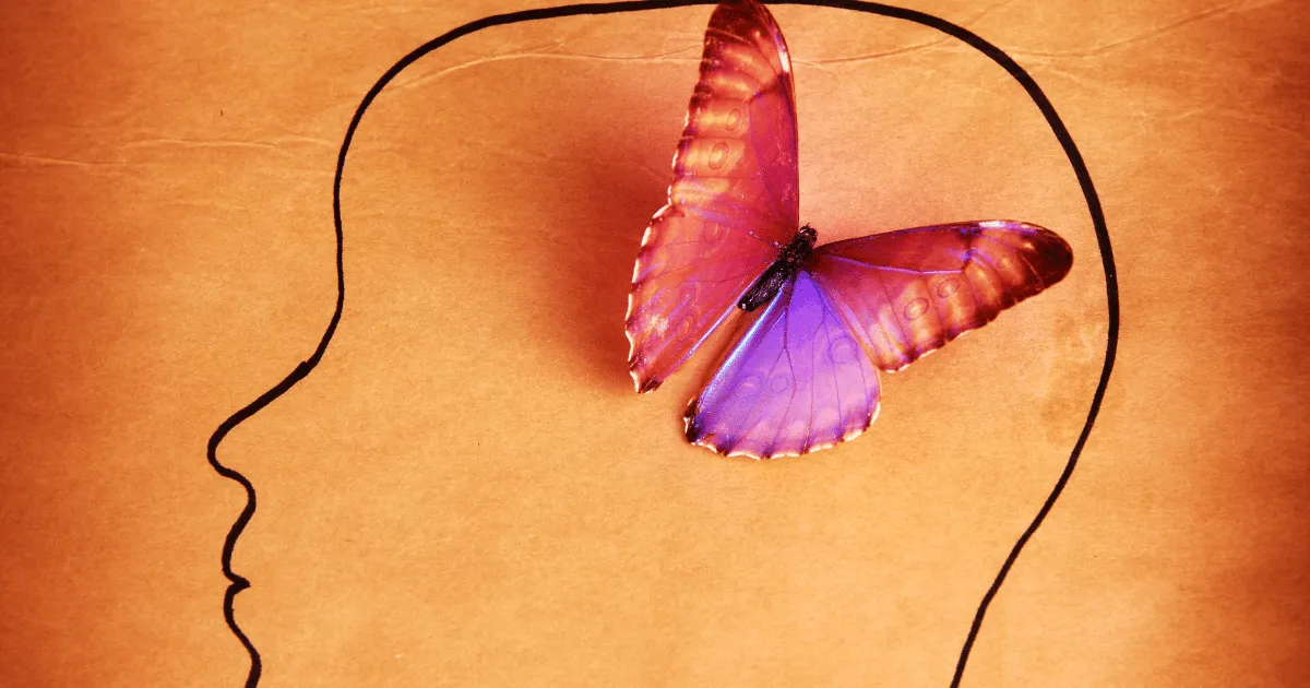 a beautiful butterfly hovers on the sketch of a human head