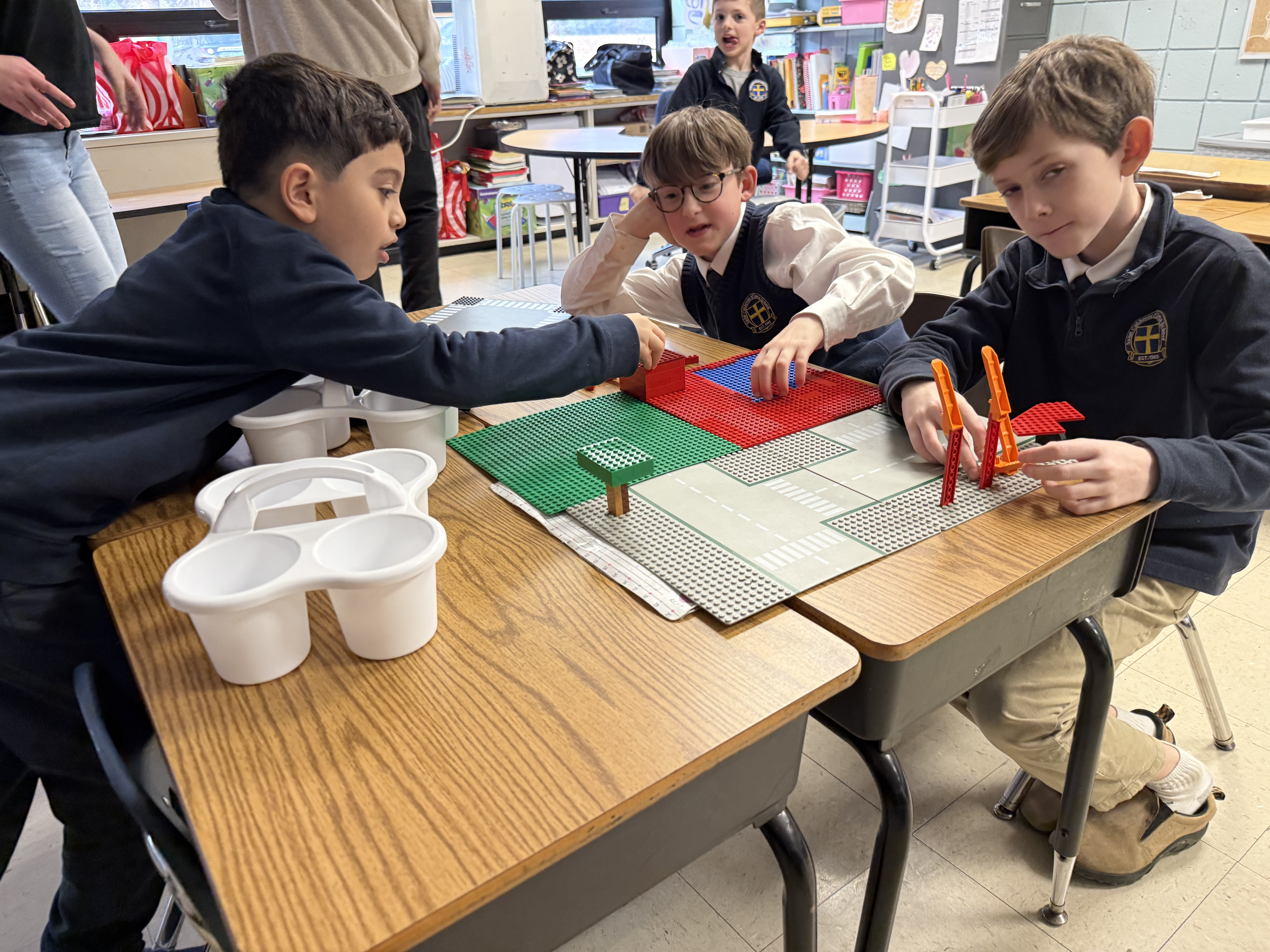 Kids collaborating and presenting their LEGO build at Brick Fusion