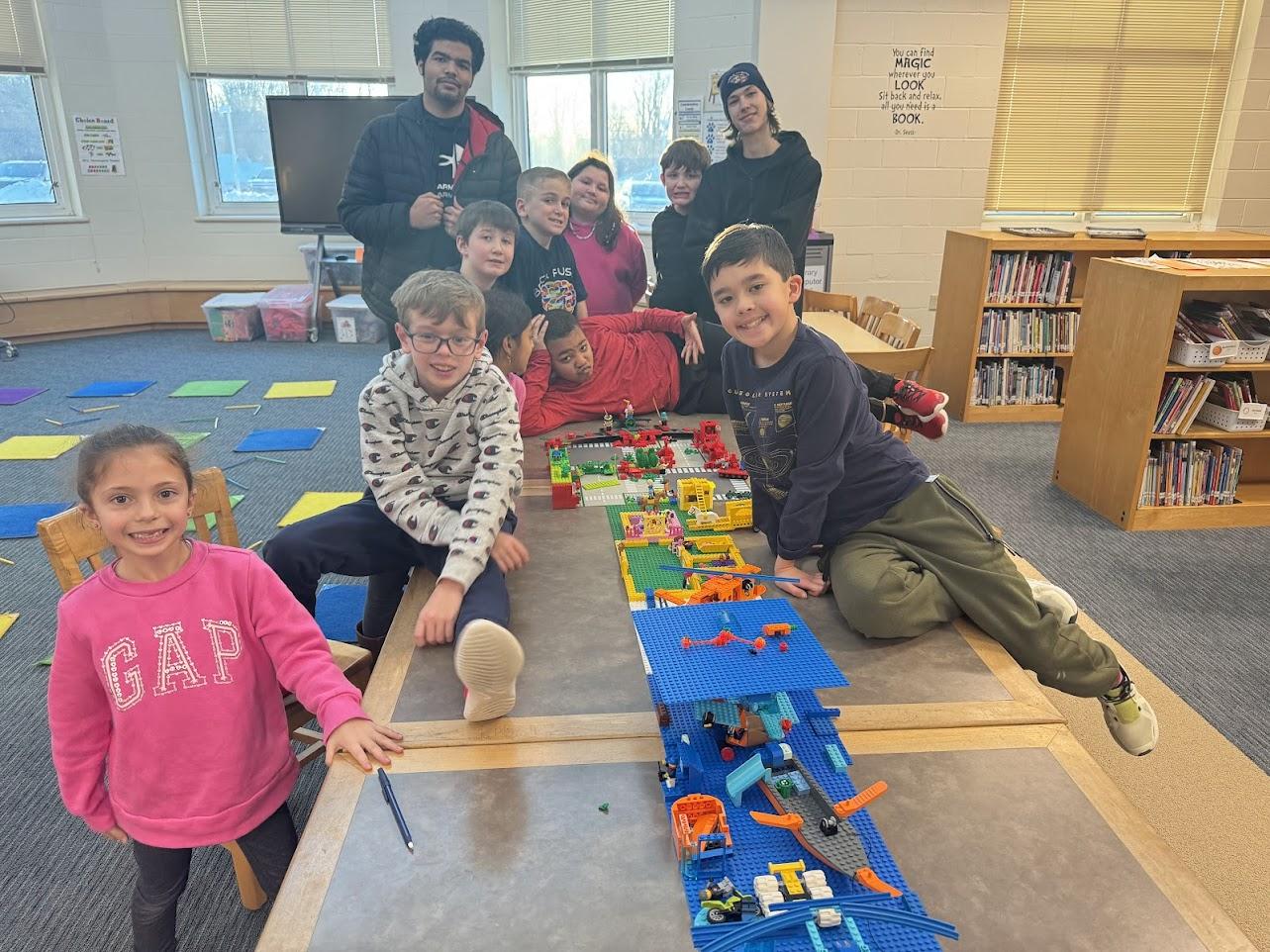 Shy child being gently supported while building with LEGO at Brick Fusion