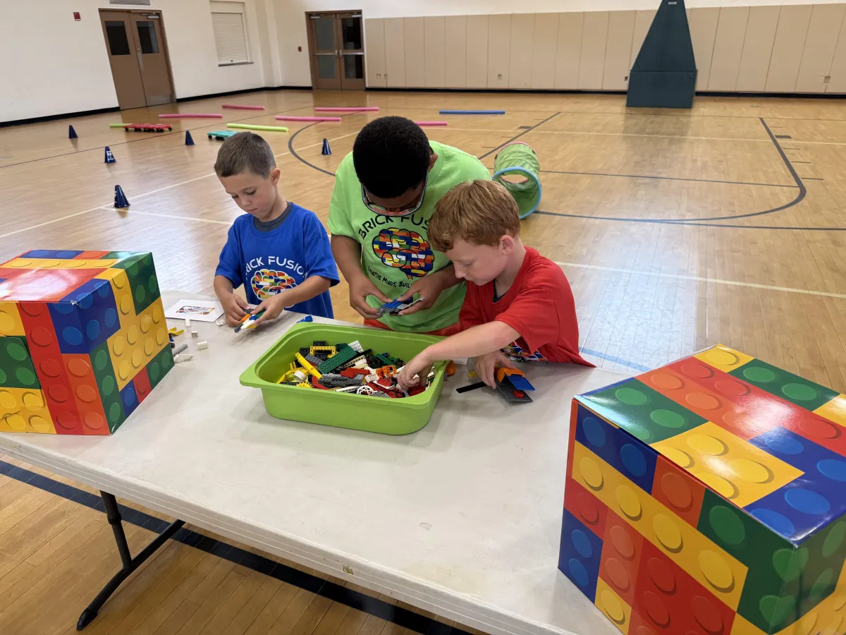 A group of kids cheering while successfully completing a high-energy engineering task