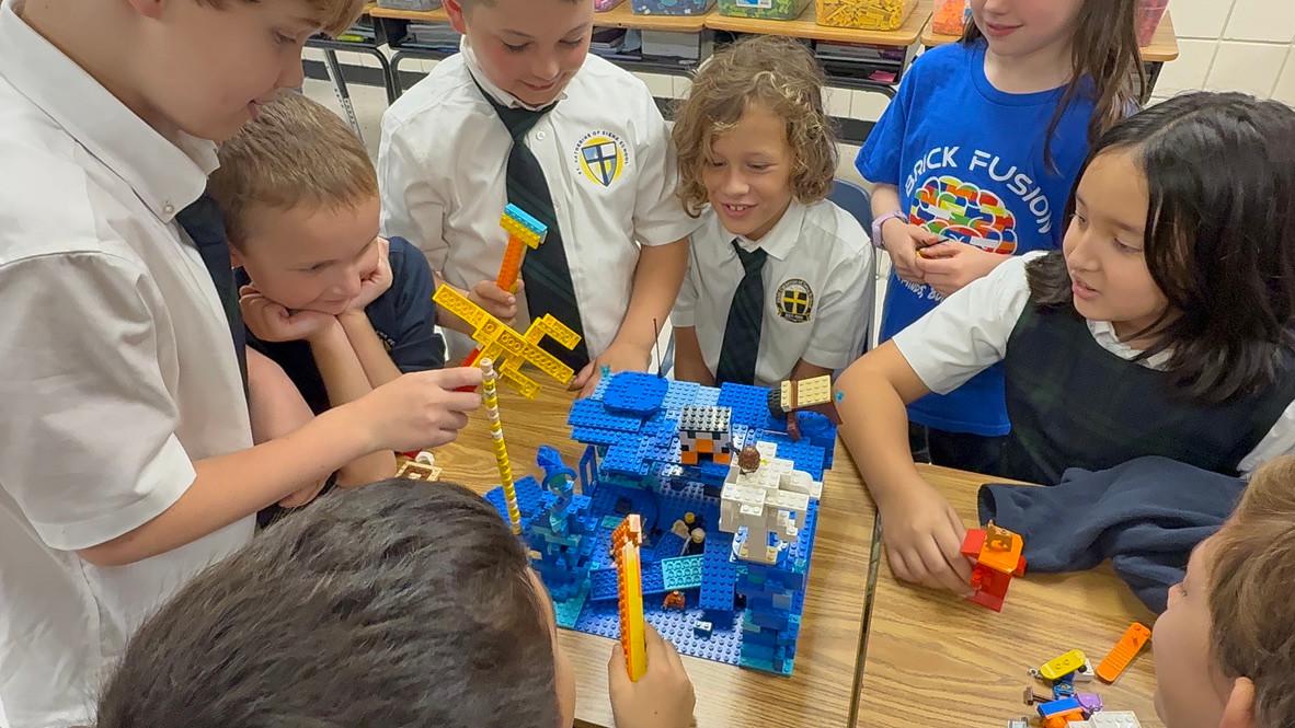 Brick Fusion participants sharing a blue LEGO build
