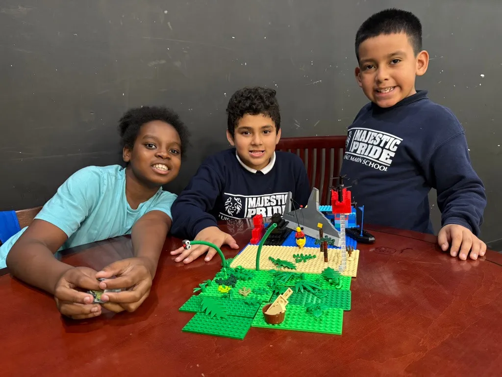 Brick Fusion group presenting a completed LEGO landscape