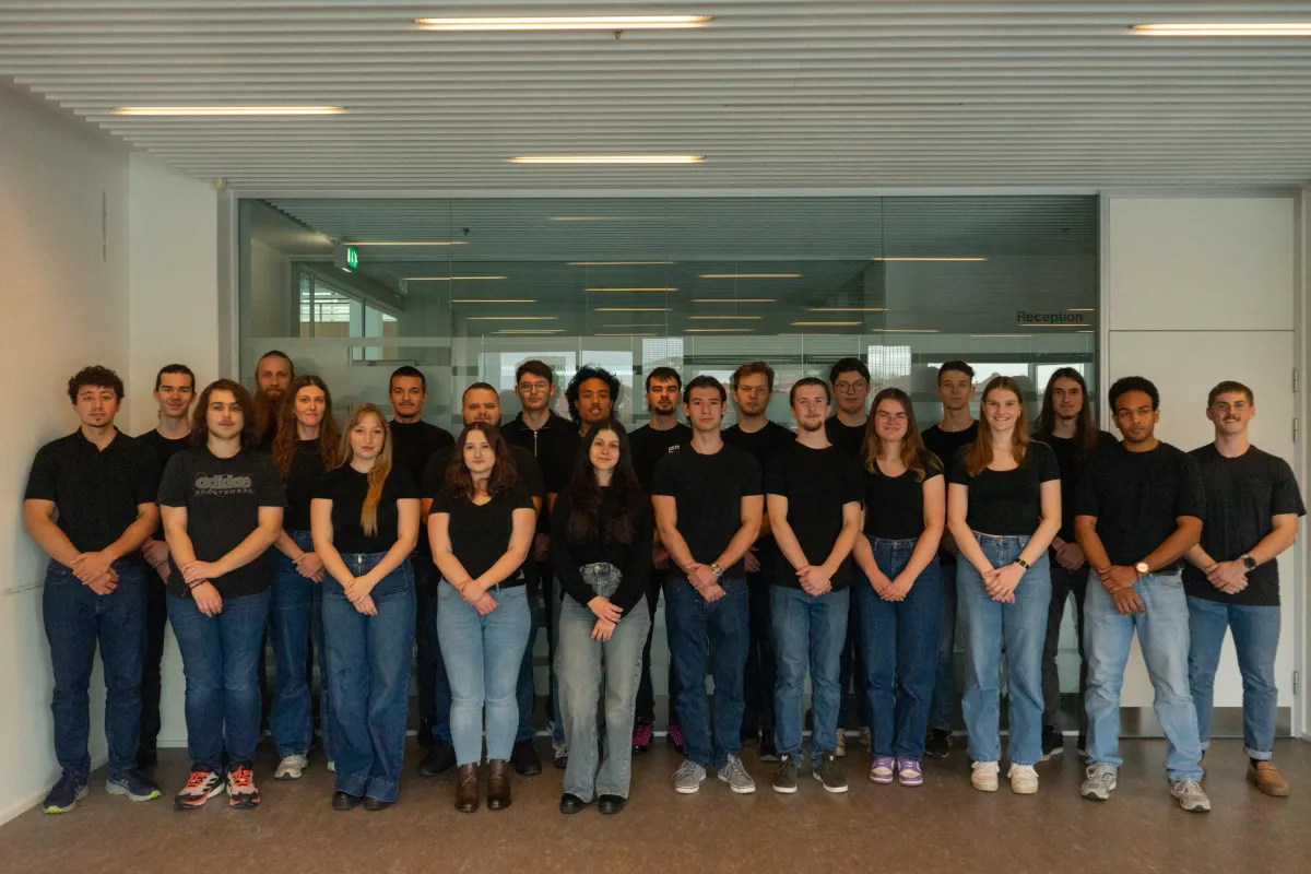 Group photo of the SDU Krakens team, all wearing black tops and blue jeans, facing the camera.