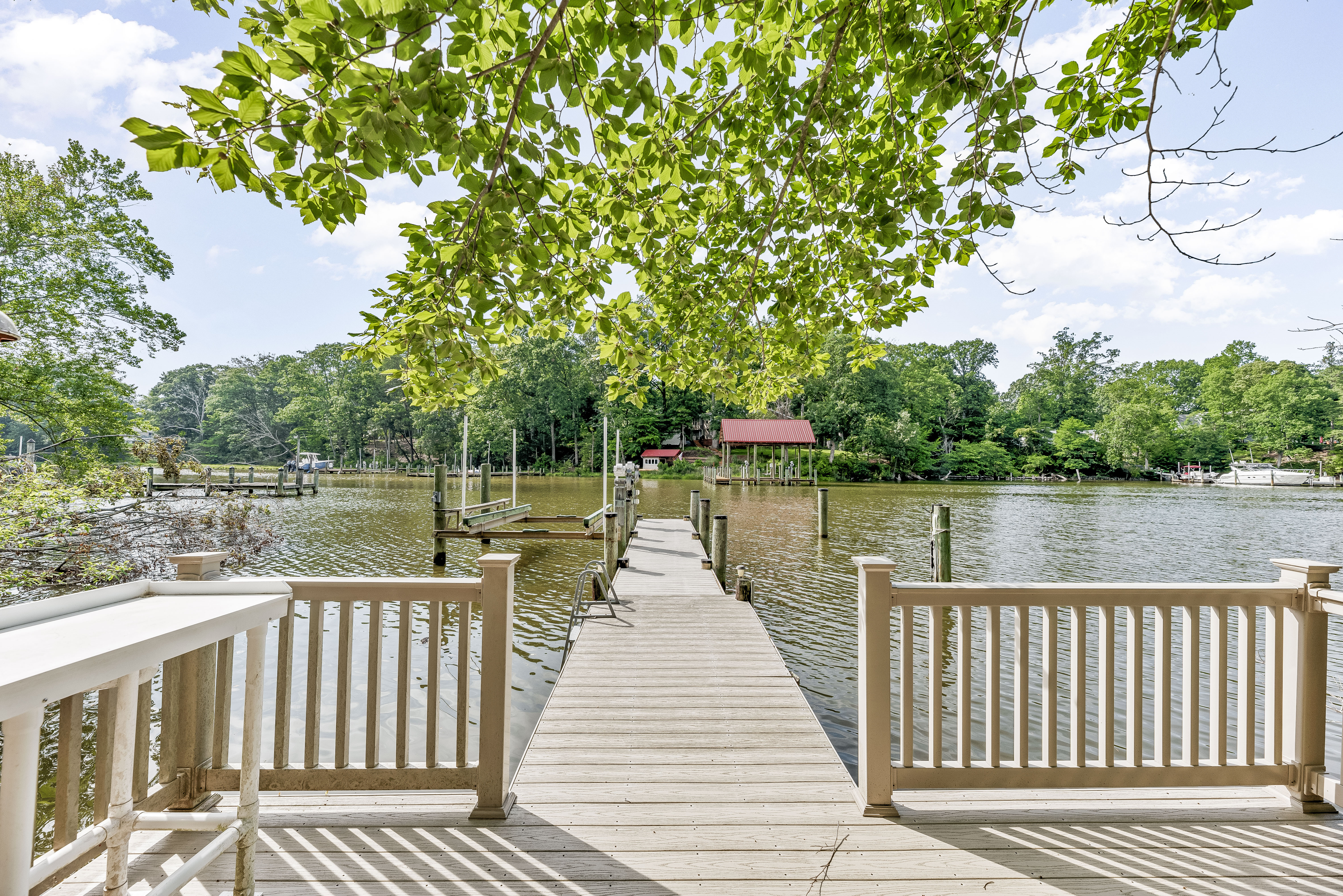 Backyard deck and private dock leading to waterfront home in Southern Maryland 