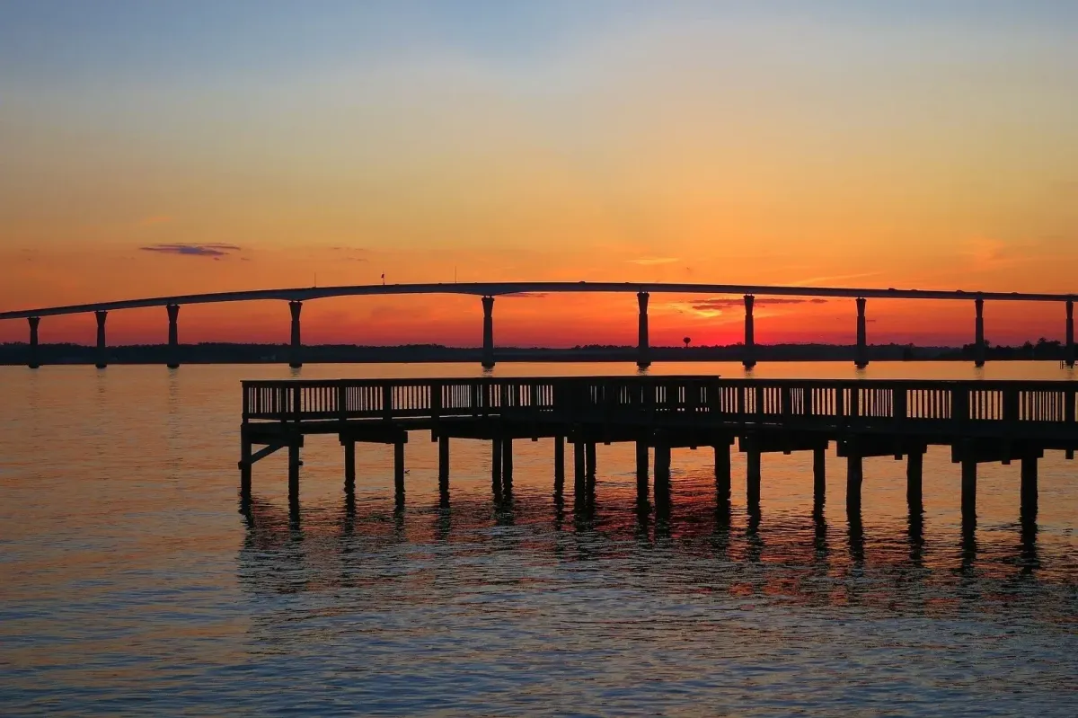 Chesapeake Bay sunset with pier and bridge in Southern Maryland waterfront community