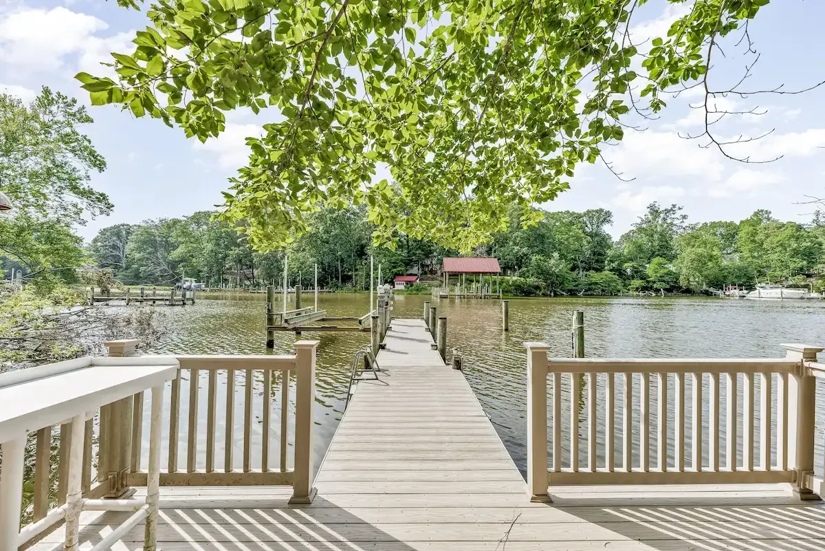 Backyard deck and private dock leading to waterfront home in Southern Maryland 