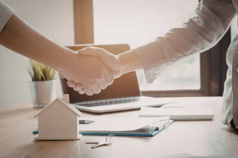 a stack of one hundred dollar bills sitting on top of a table