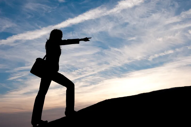 A small house bank with a coin and blank card.