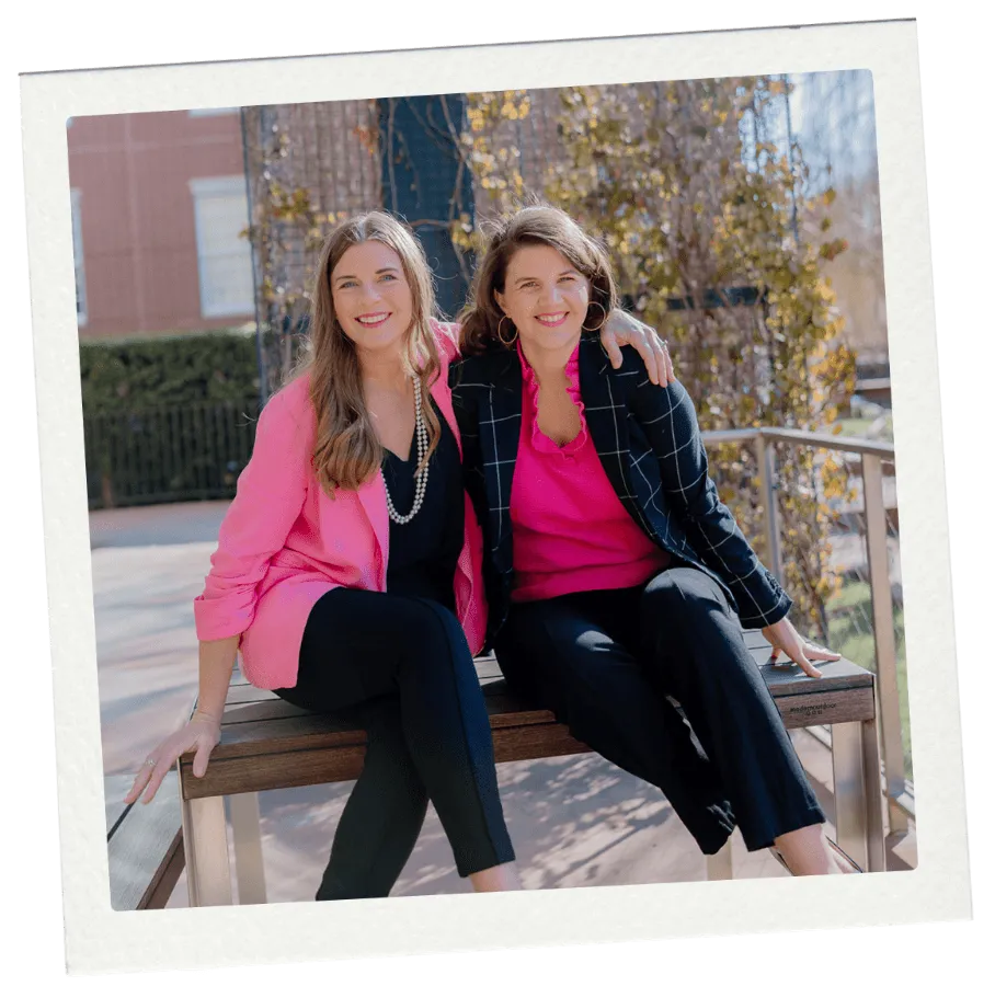 Autumn and Lizanne, admissions coaches, sitting on a campus bench