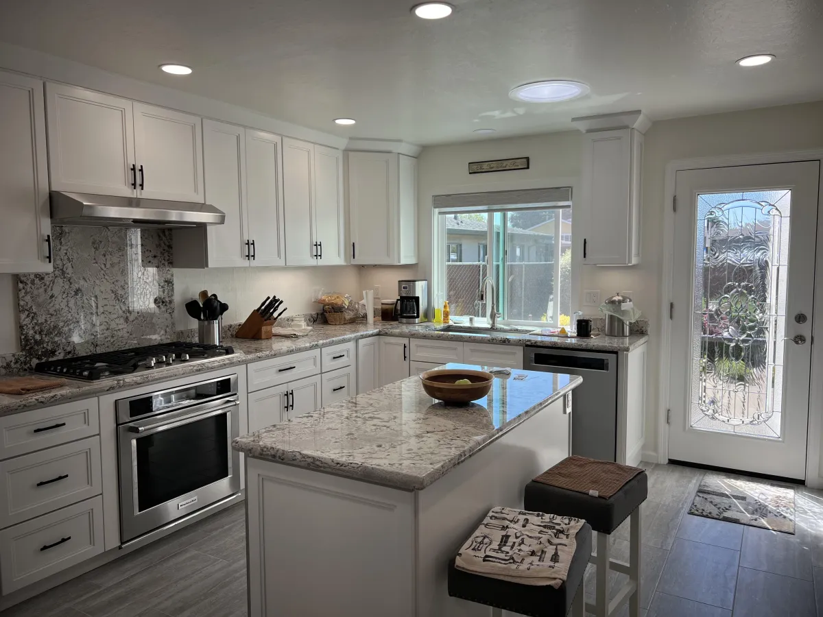 Remodeled kitchen, white cabinets with granite top
