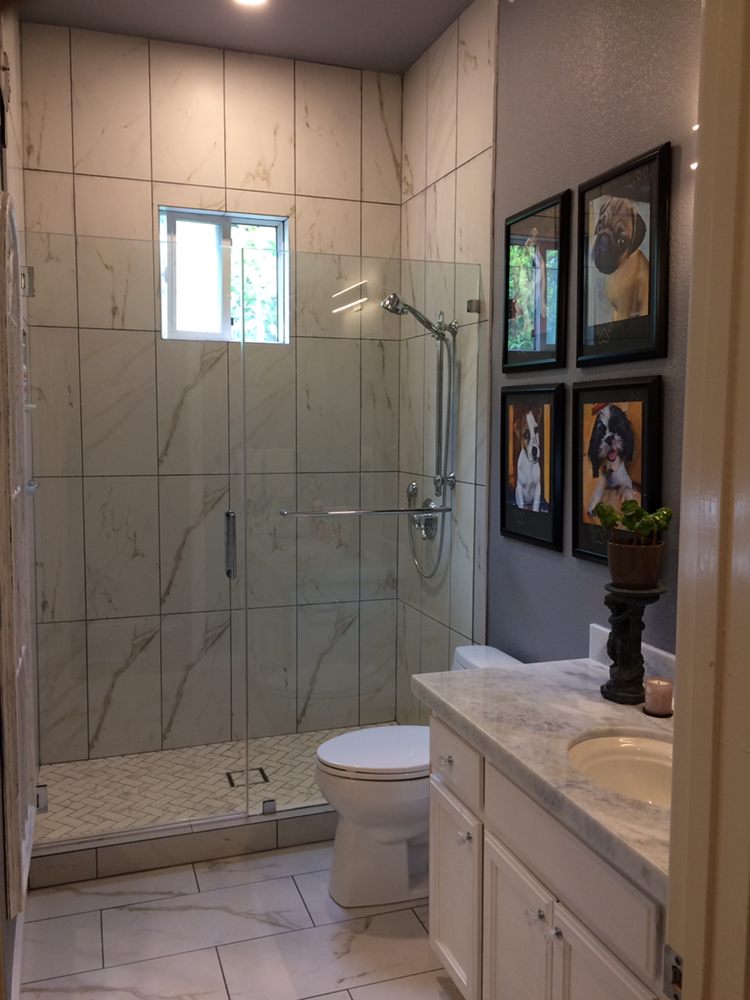 Bathroom with base cabinets and shower enclosure and cozy lighting
