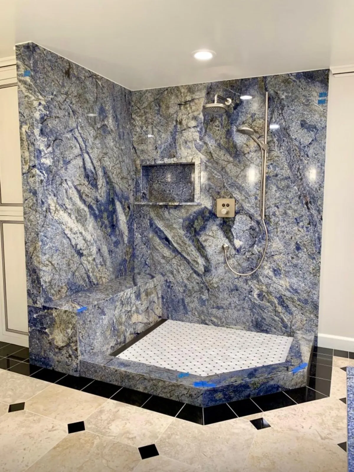 Bathroom shower area with granite wall cladding