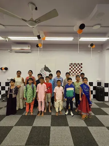 Students standing in front of the CHESS KLUB logo.