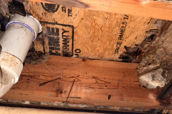 Water damage around plumbing and wood framing in a Knoxville home