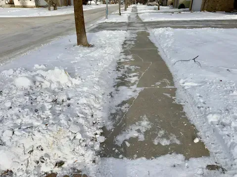 Sidewalk snow clearing in Cedar Falls by Cedar Falls Lawn and Snow