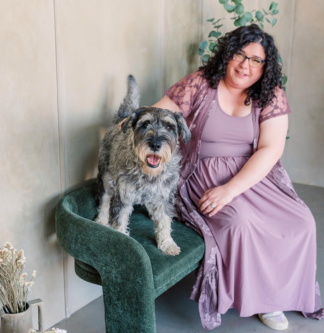 Ruth Hirshberg sitting with her dog Huron beside her.