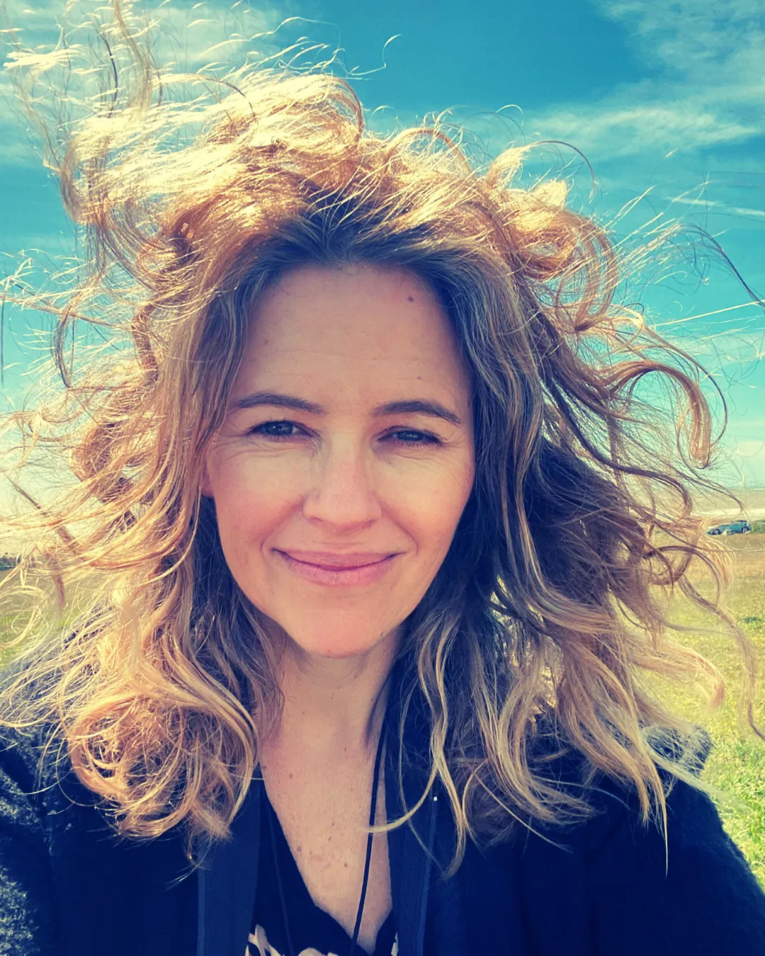 grayscale and selective focus photography of woman playing guitar