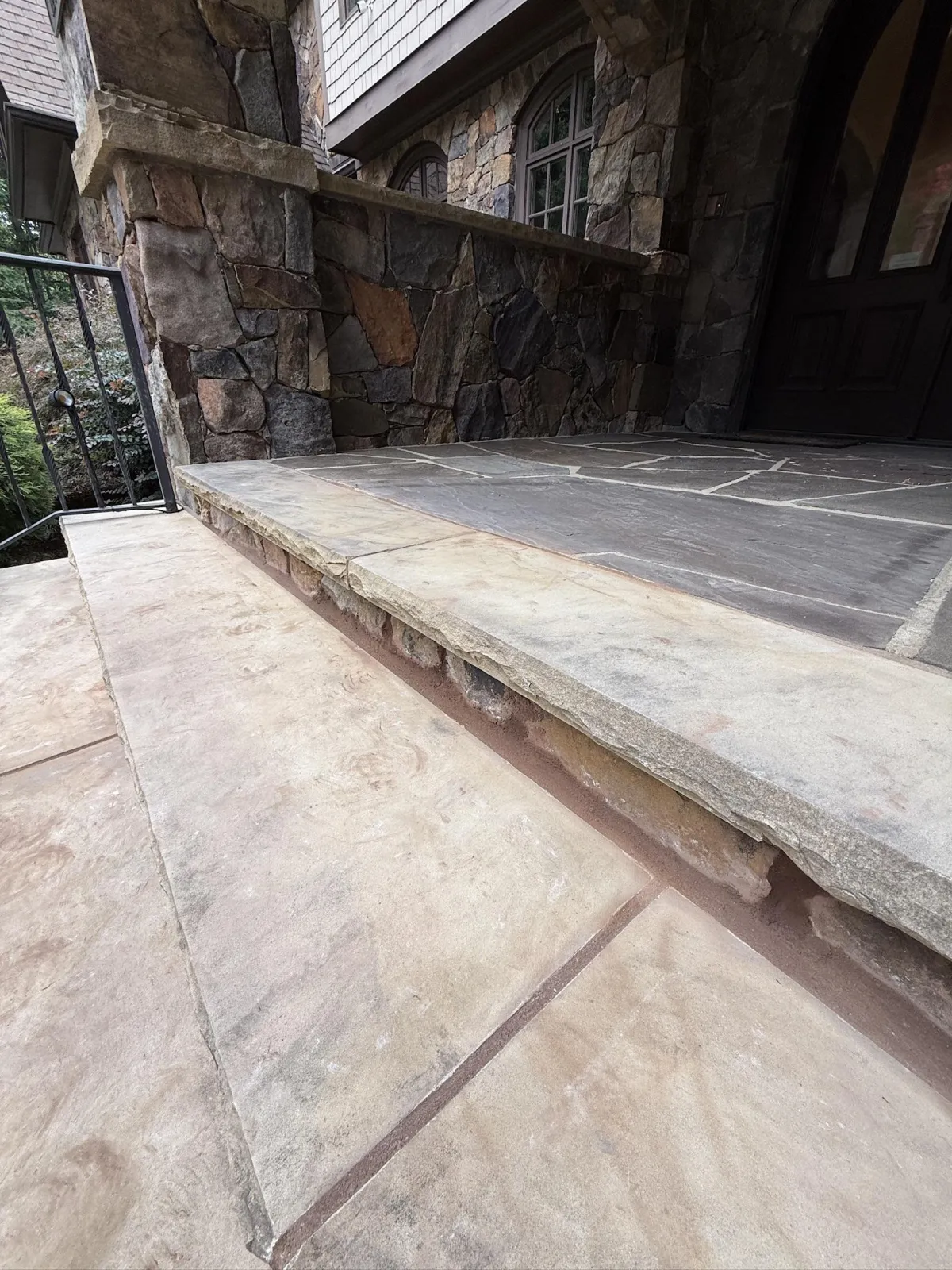 Close-up of exterior stone steps with clean, finished mortar joints.