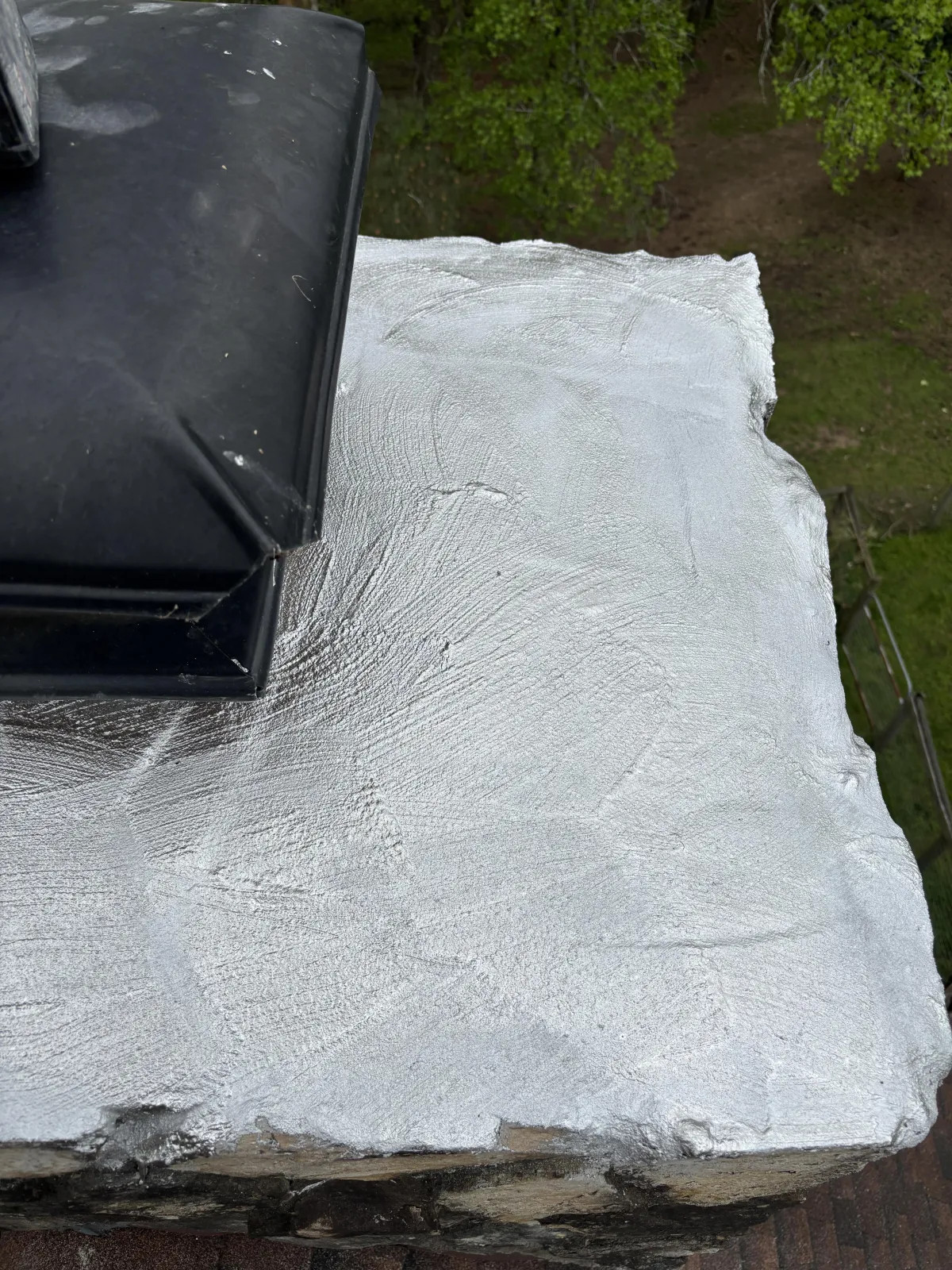 Close-up of a cleaned fireplace firebox with a cleared fireplace firebox with a cleared floor, exposed brick, and an ash dump door.