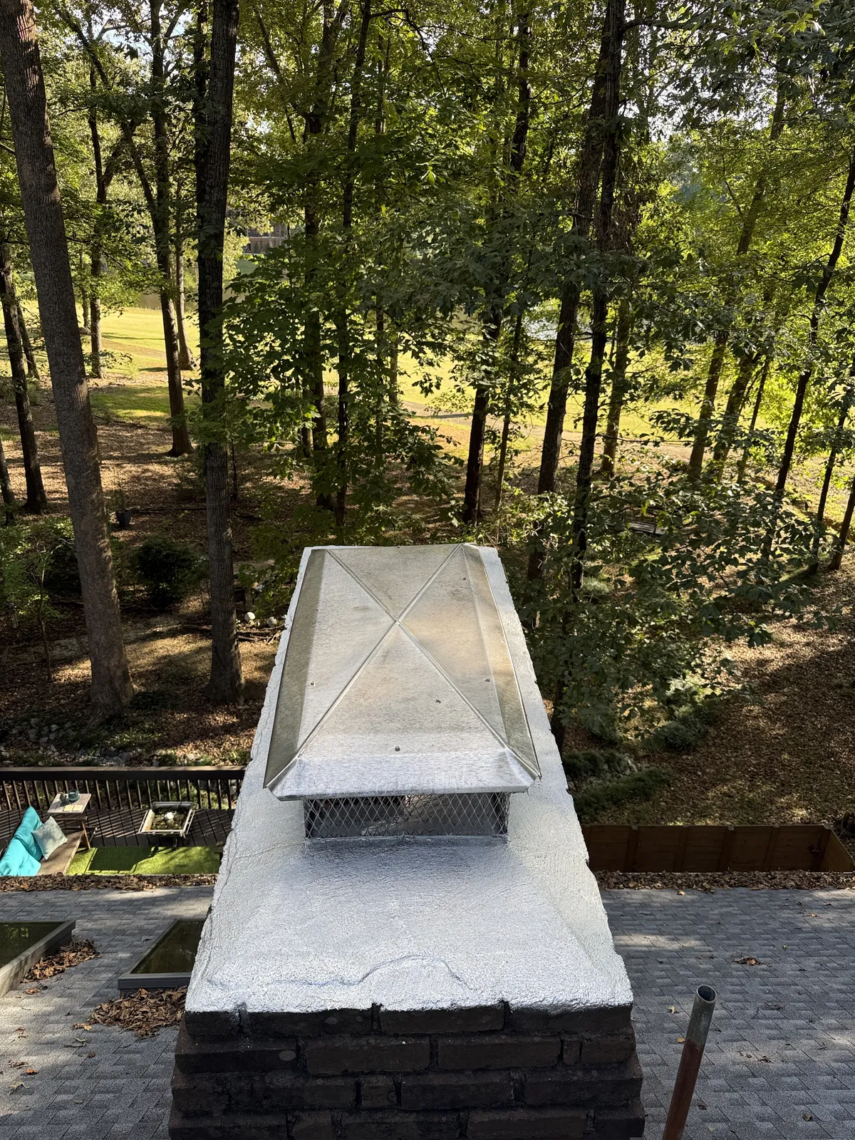 Newly installed stainless steel chimney cap and protective crown seal for fireplace rain prevention