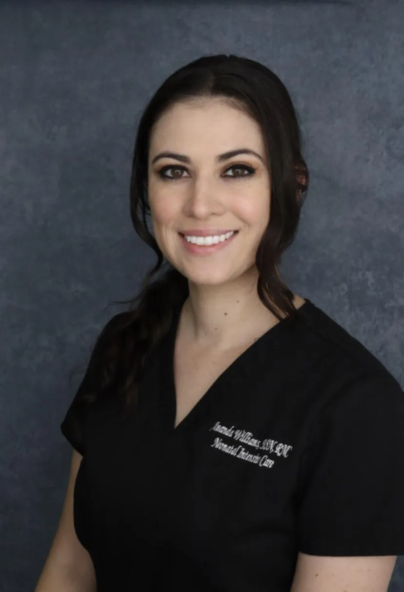 Amanda Williams CNS wearing black scrubs with pink stethoscope around her neck