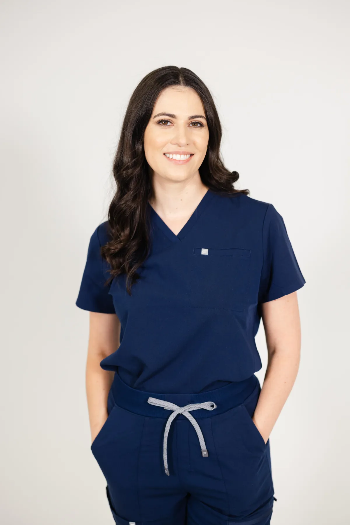 Amanda Williams CNS wearing black scrubs with pink stethoscope around her neck