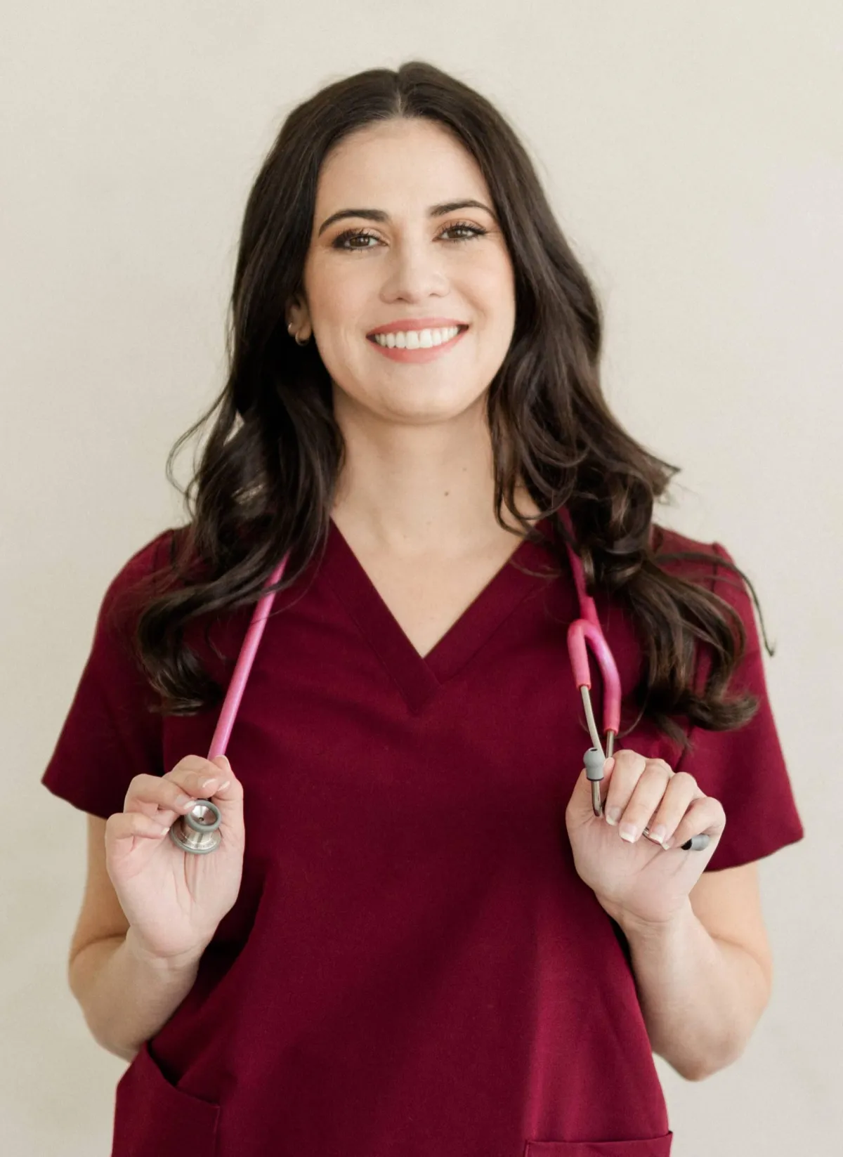 Amanda Williams CNS wearing black scrubs with pink stethoscope around her neck