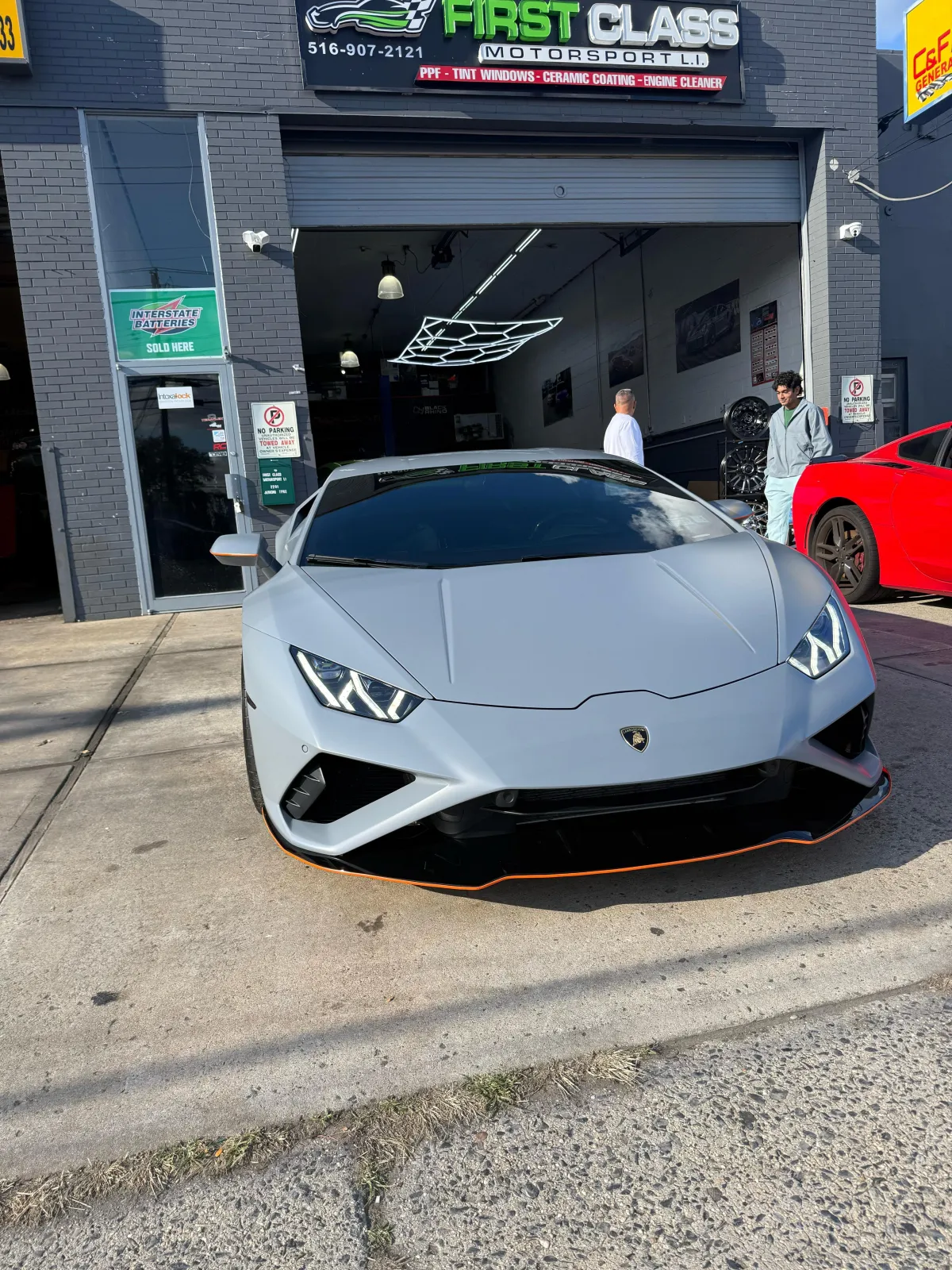 Luxury auto workshop interior with premium vehicles