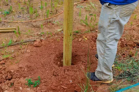 Fence post installation during new fence build by Brownsville Fence Contractors
