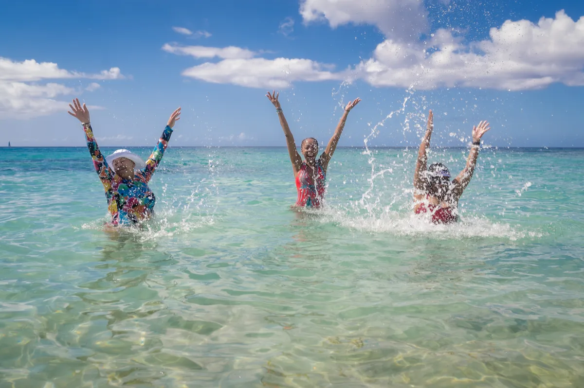 Women jumping in the ocean during the WANTED Woman Escape in Grenada Caribbean