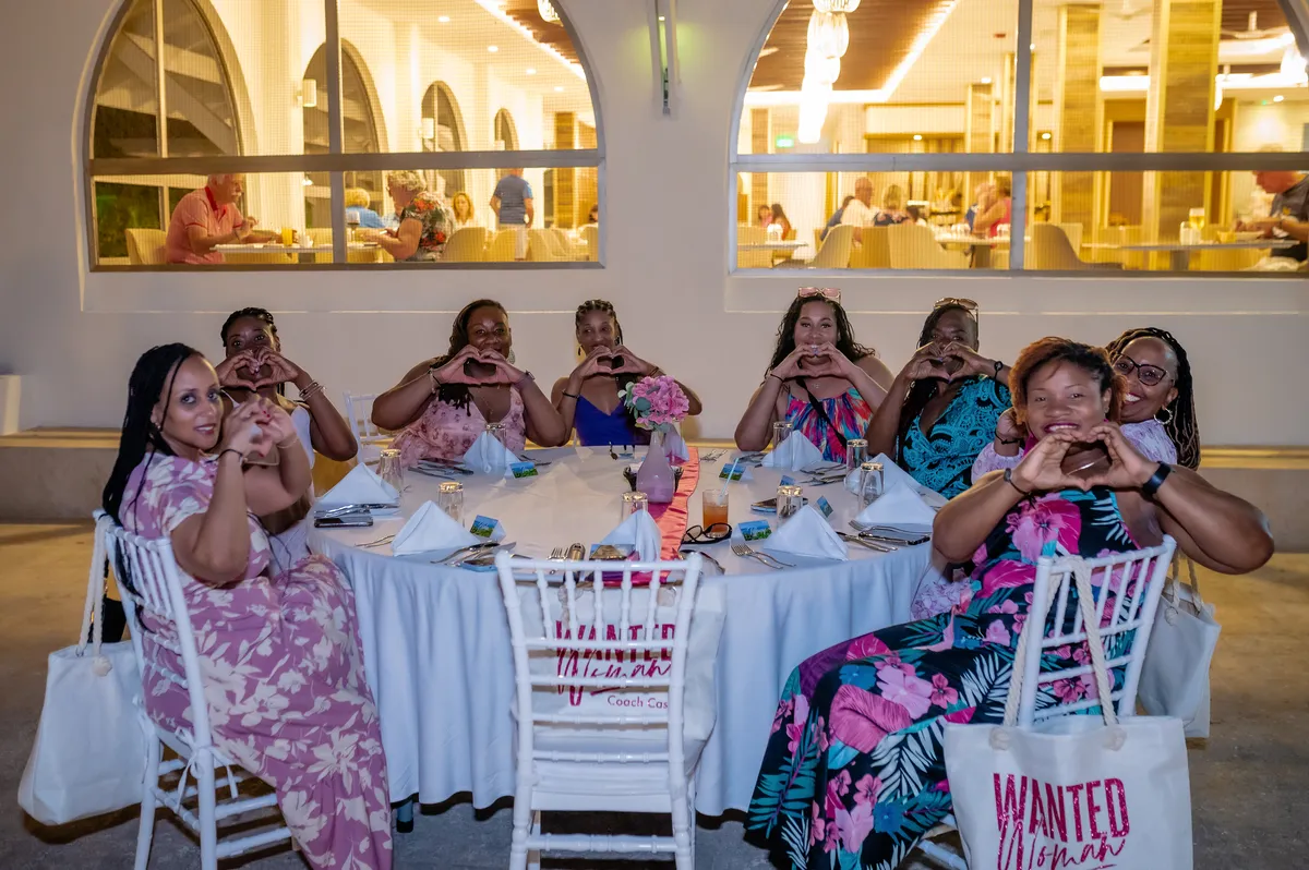 Women enjoying dinner together during the WANTED Woman Escape in Grenada